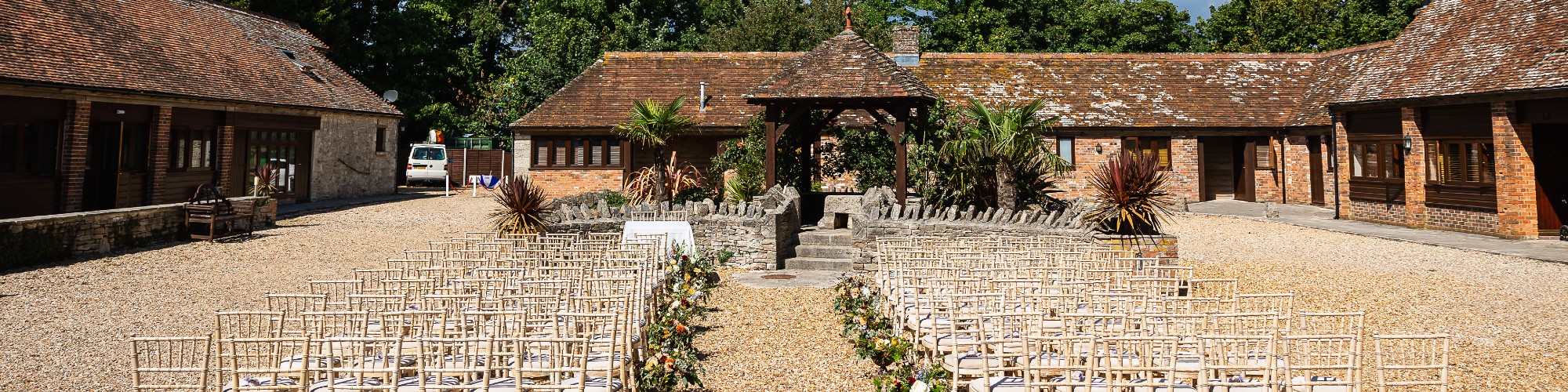 Kingston Country Courtyard outside ceremony with chairs