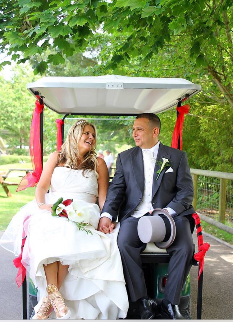 Couple riding in golf buggy