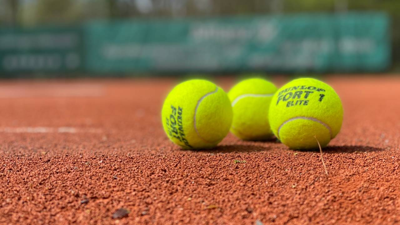 Picture of 3 tennis balls lying on the ground