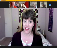 A video call with a woman presenting and small screens above her showing people attending the meeting