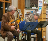 Two men playing instruments - violins