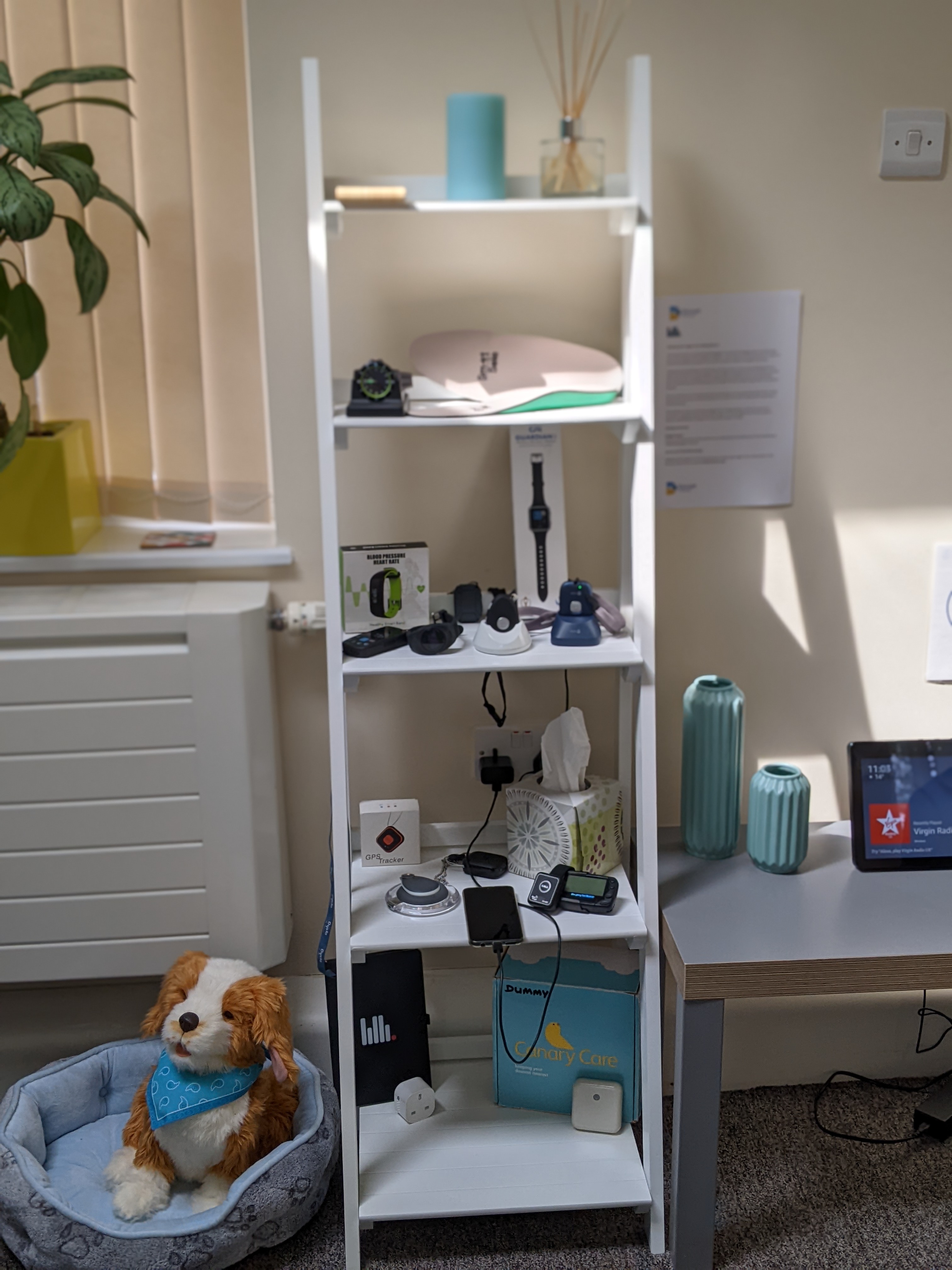 Various items of technology displayed on shelves