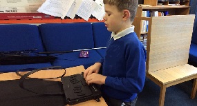 Boy using Braillenote