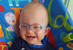 Smiling baby in glasses