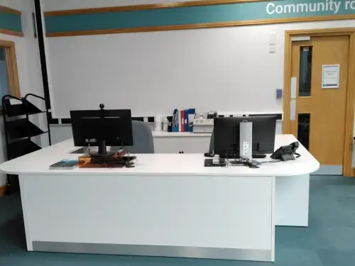 This is an image of the front desk with two computer screens and keyboards.