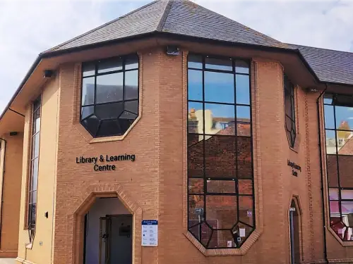 This is an image of the outside of Weymouth Library, a red brick building.