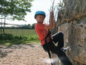 Young boy abseiling at Weymouth Outdoor Education Centre
