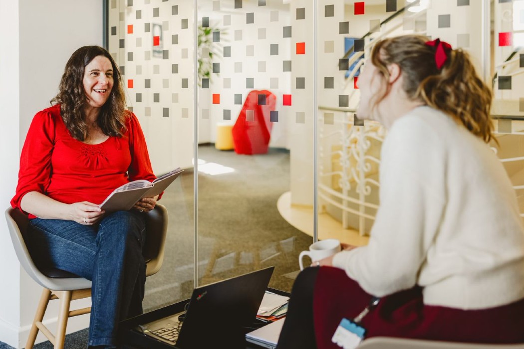 Two women in conversation in an office setting