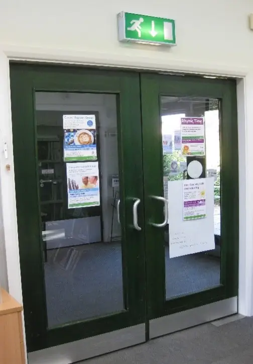 This is a picture of the double green exit doors which are closed.