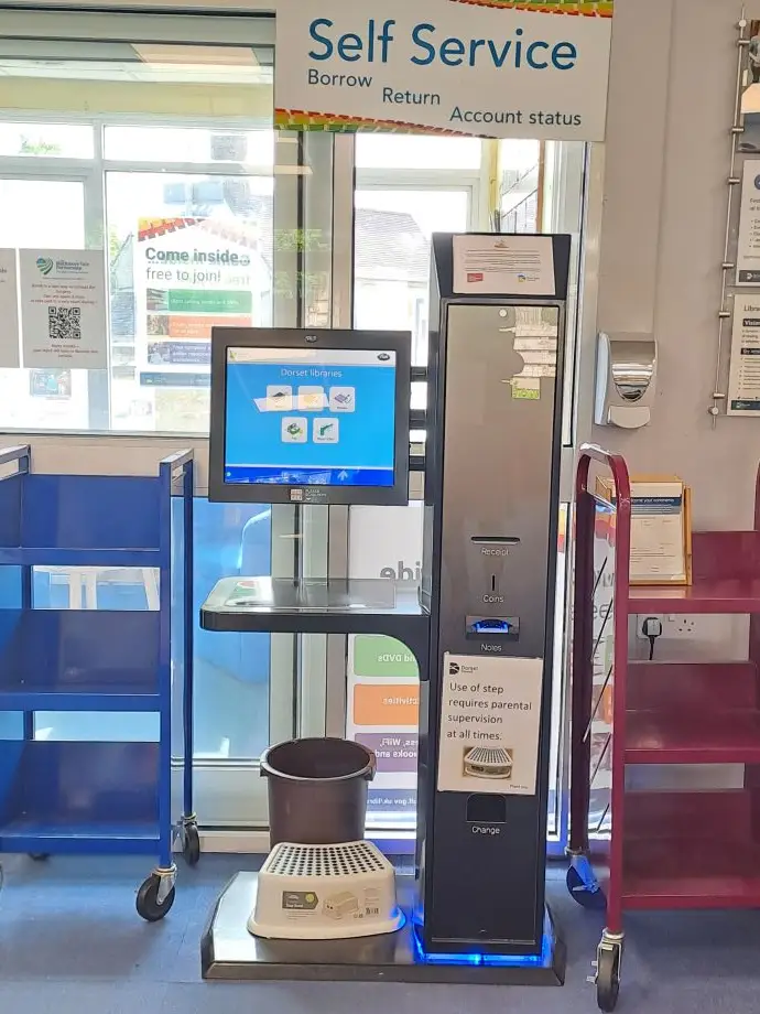 This is a picture of a self service machine to check in and out books and dvds.