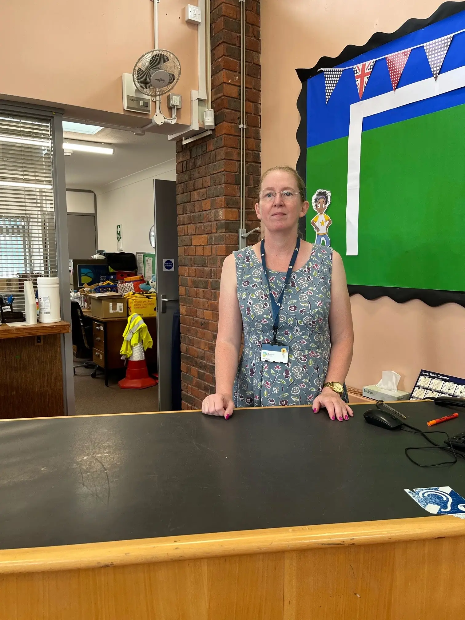 This is a picture of the Library Manager standing behind the front desk.