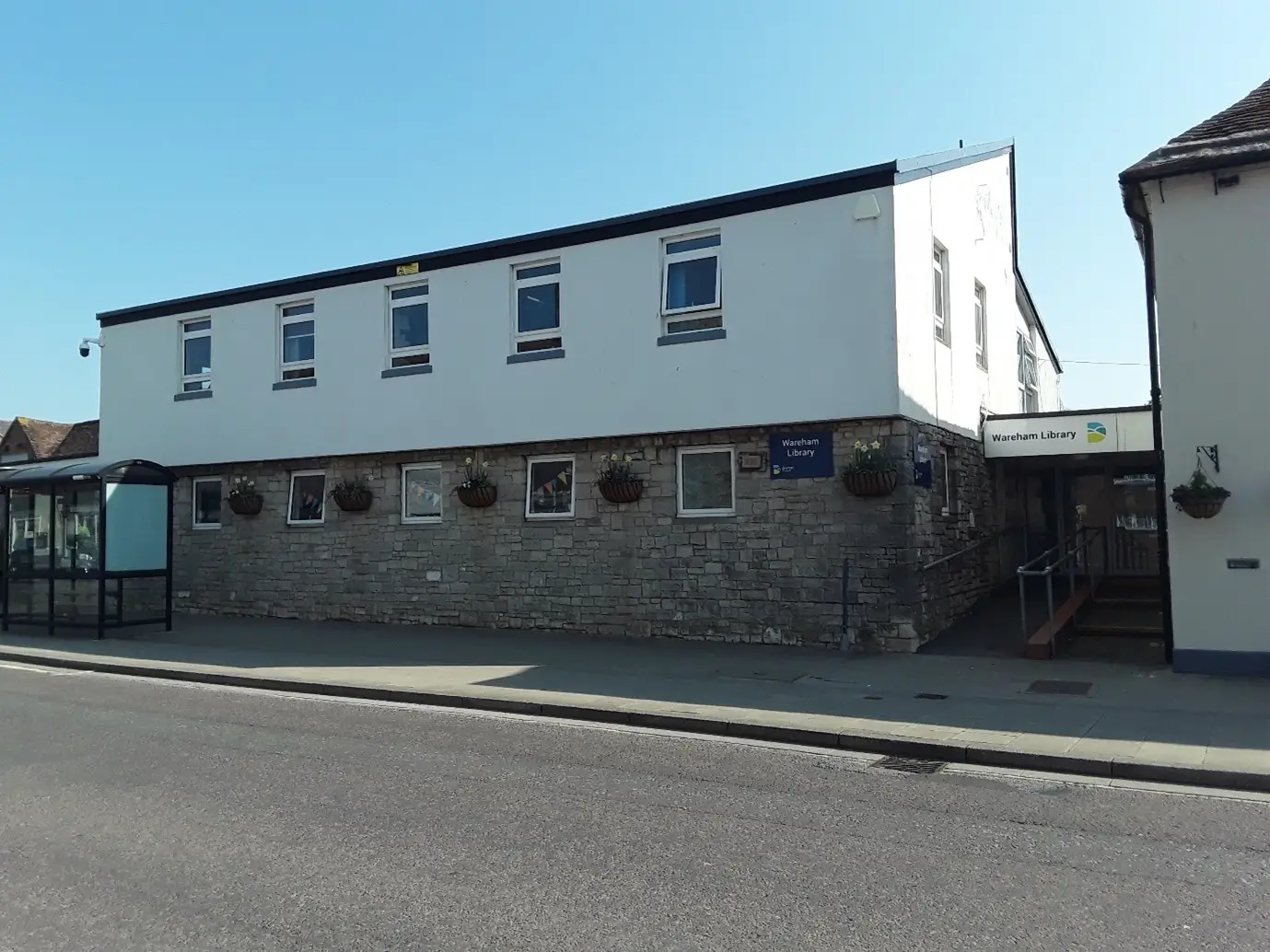 This is a picture of the front of Wareham Library with an entrance to the right side of the building.