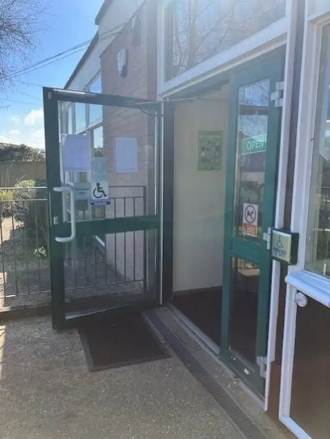This is a picture of the entrance to the library, the door is open.