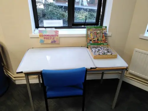 This is an image of the puzzle area of the library with a desk and chair.