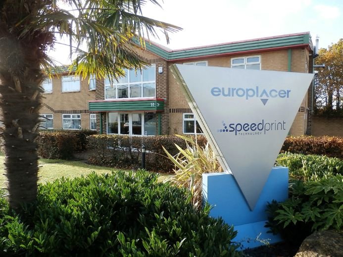 Exterior of Blakell Europlacer building with a sign displaying 'Europlacer' and 'Speedprint Technology', surrounded by landscaped greenery.