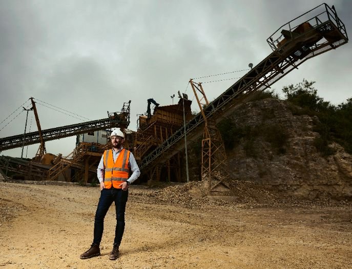 Person stood in front of quarry equipment