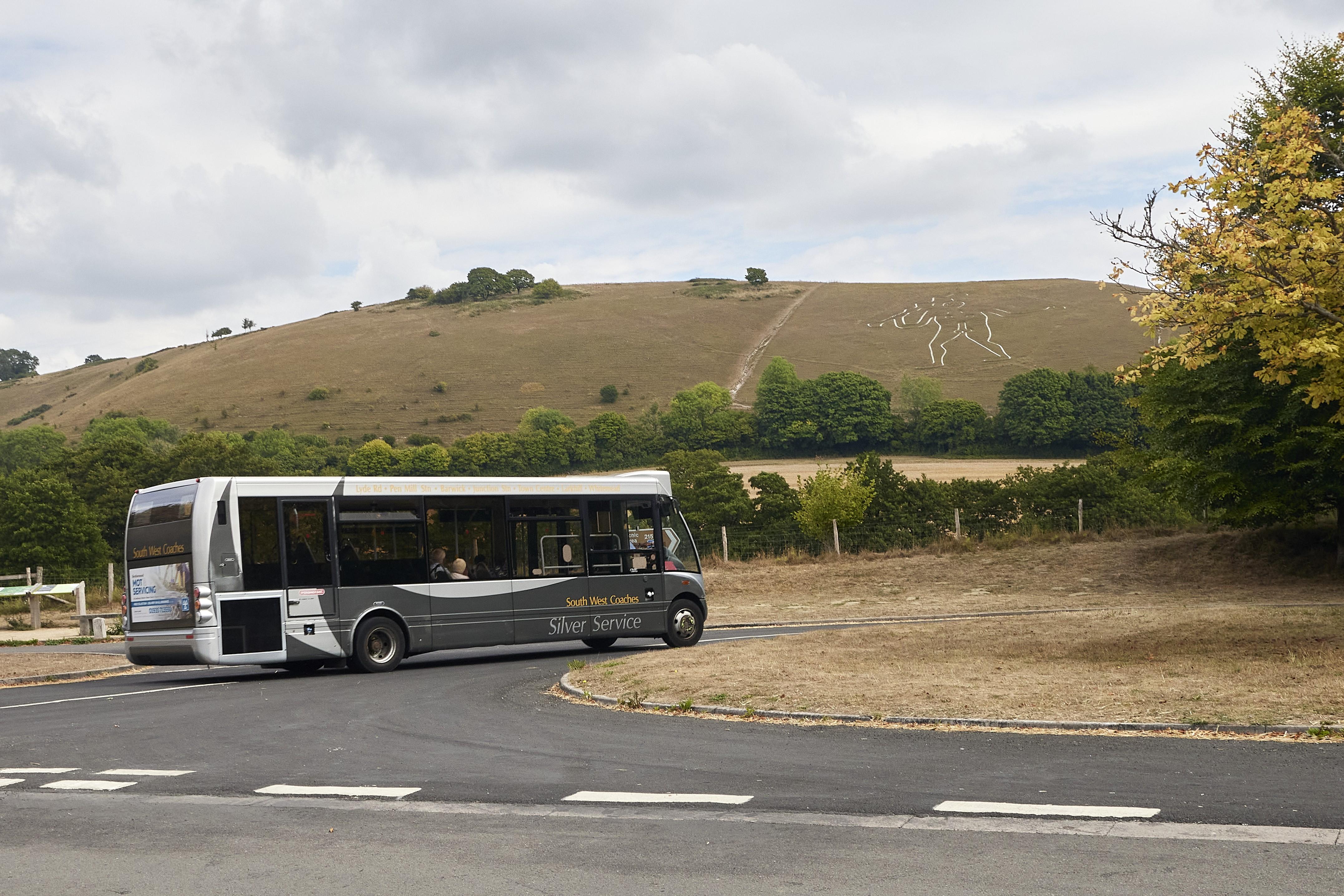 Bus driving on road in Cerne Abbas