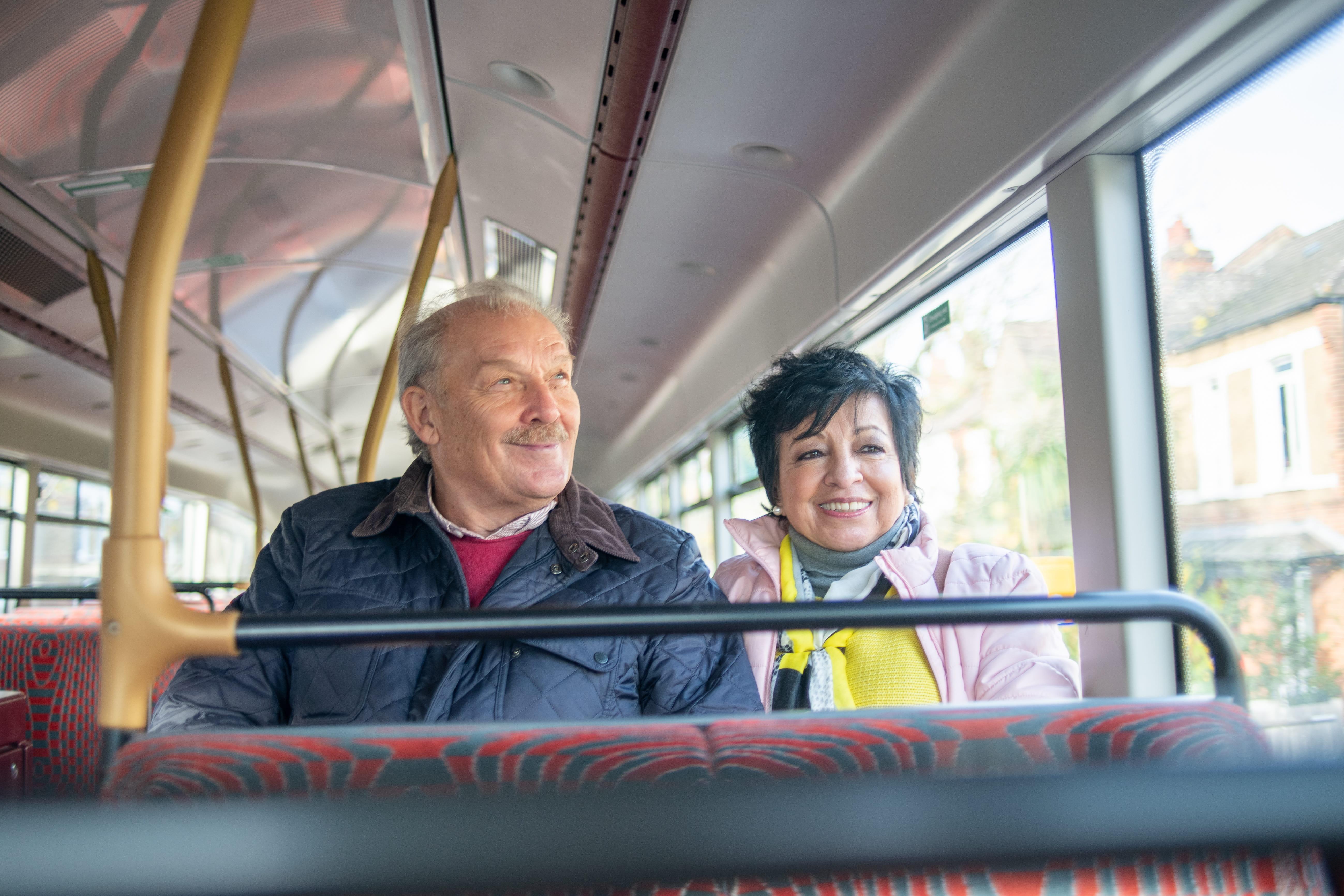 2 people sat on the top storey of a bus