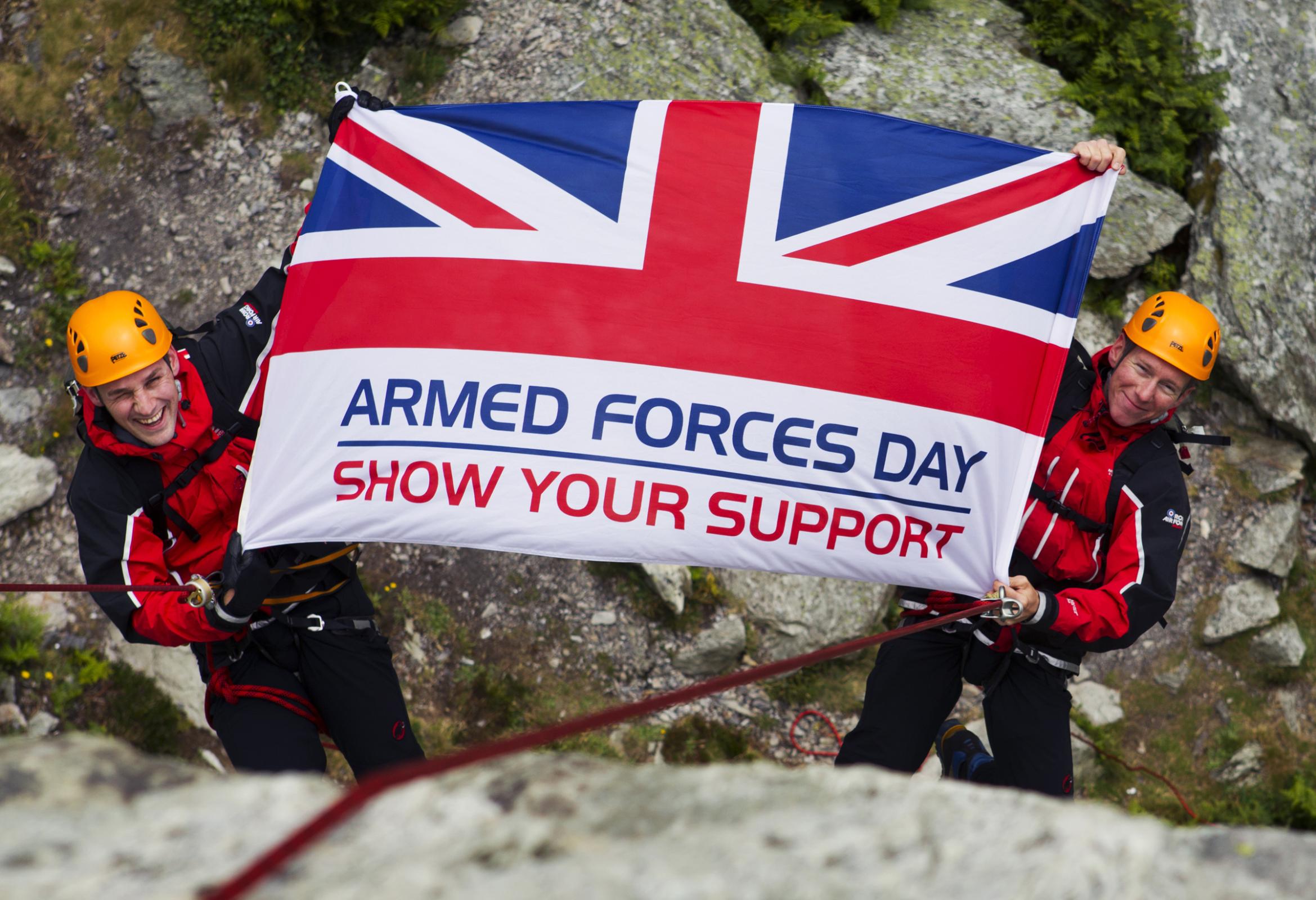 Armed Forces Flag held by two mountaineers saying show your support