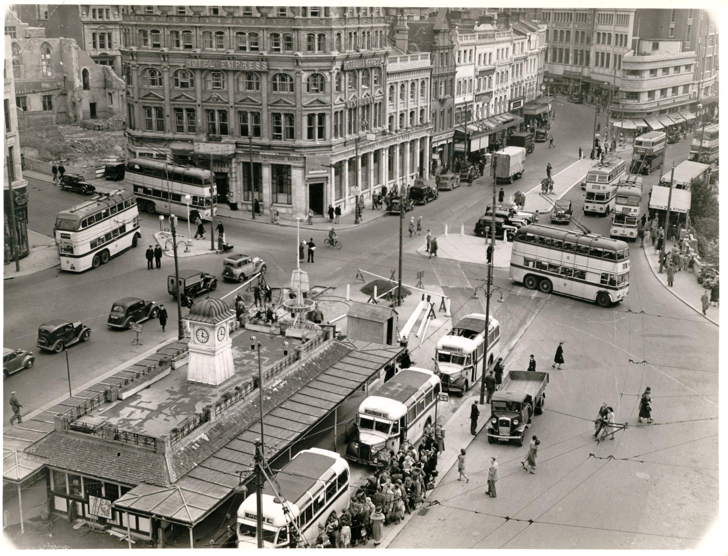 An old black and white photo of Yellow Buses in the centre of Bournemouth - what is now the pedestrianised square. The view is from an upper level of Bobby&#39;s department store.