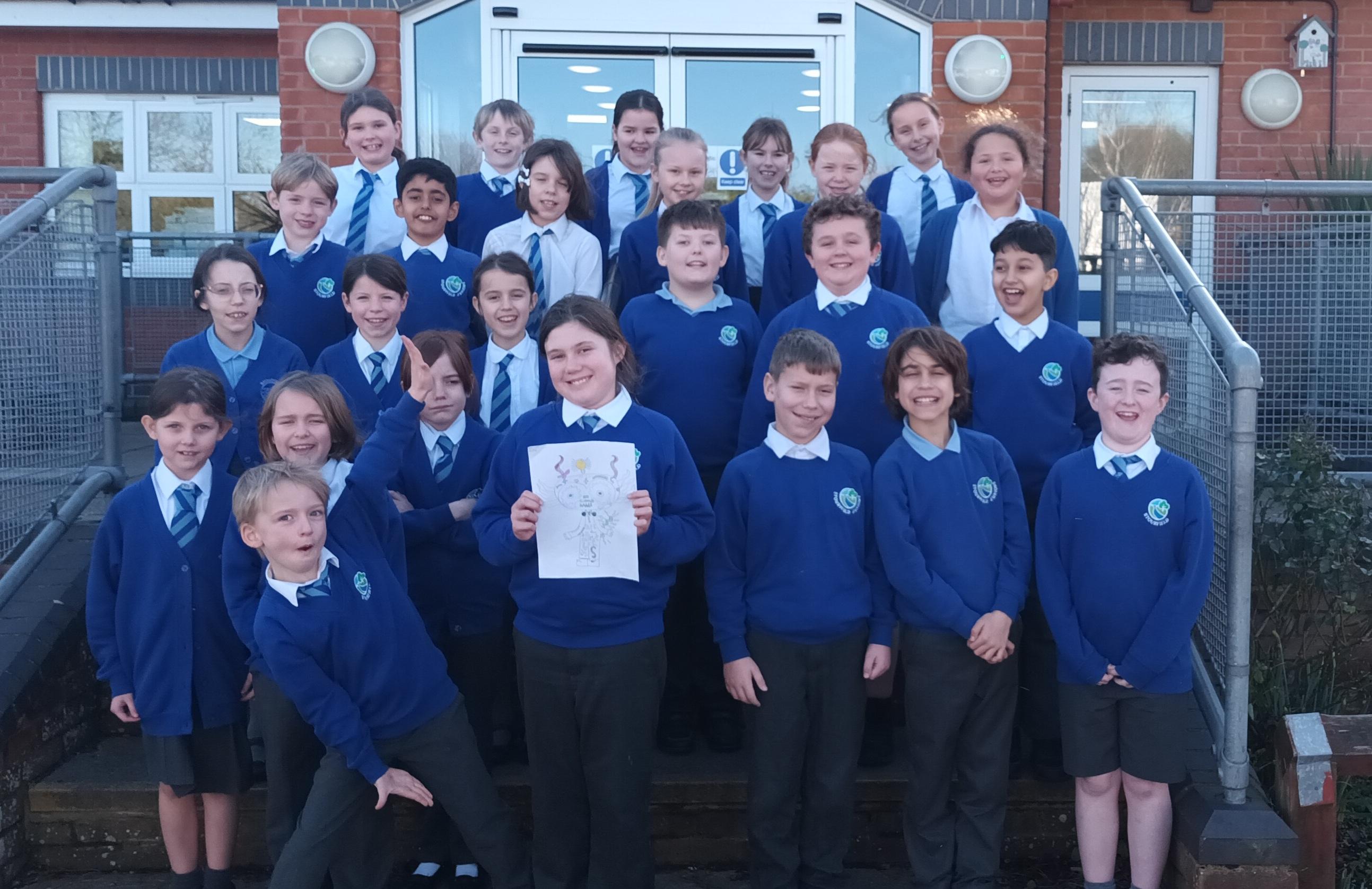 A large group of school children wearing royal blue jumpers and cardigans and grey trousers and skirts.