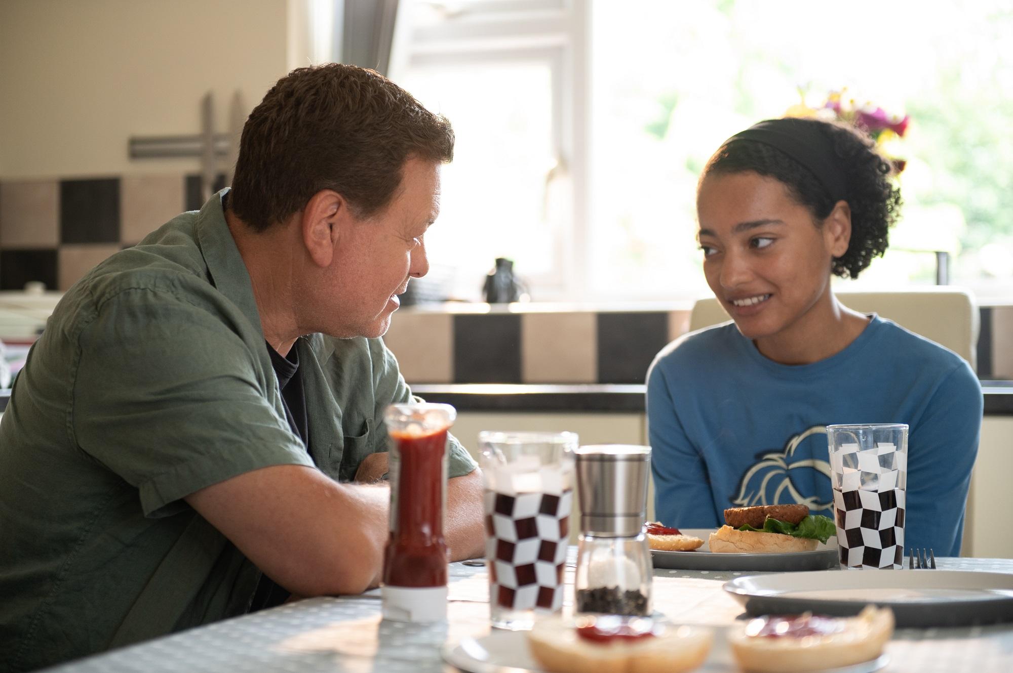Mike is sitting with Zara at the kitchen table. He&#39;s given her her favourite meal and they&#39;re talking