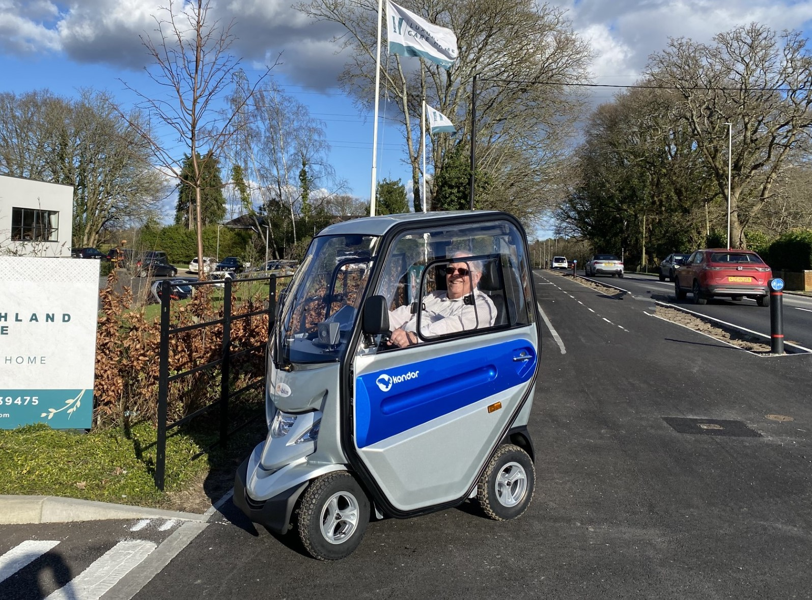 A man seated in a mobility scooter