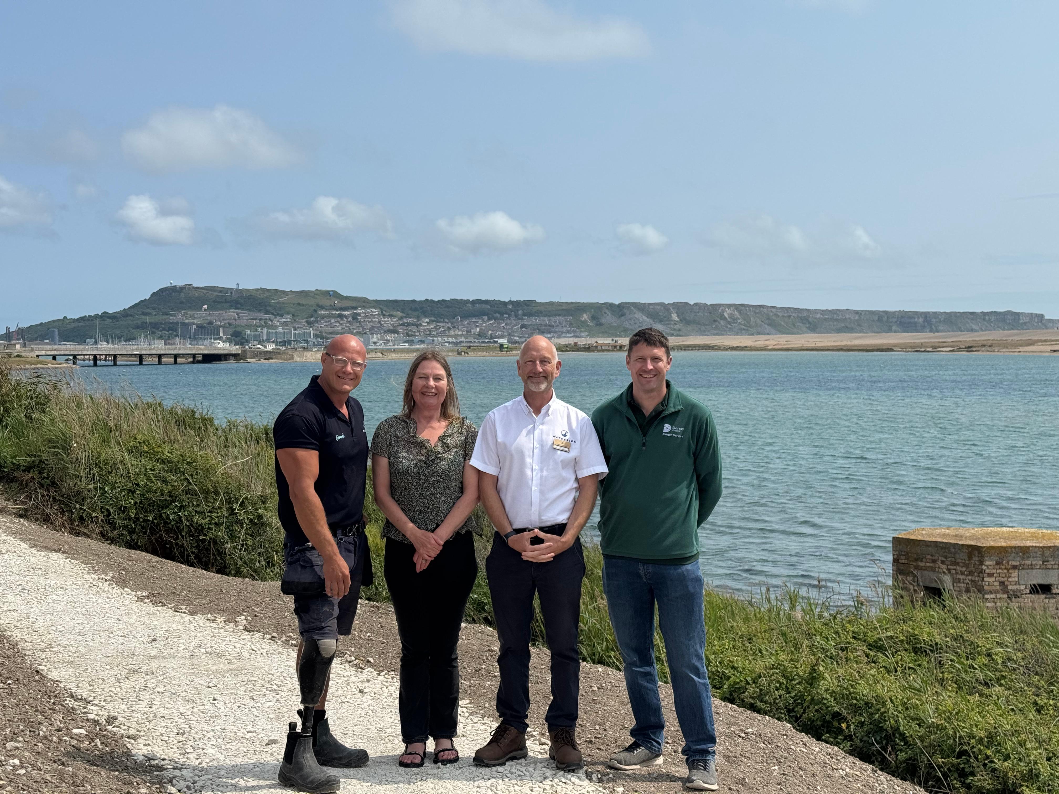 the photos are, from left: Daniel Pullenger, Waterside Groundsman; Cllr Clare Sutton, Matt Way, Waterside Operations Director; and Russell Goff, Greenspace Manager at Dorset Council