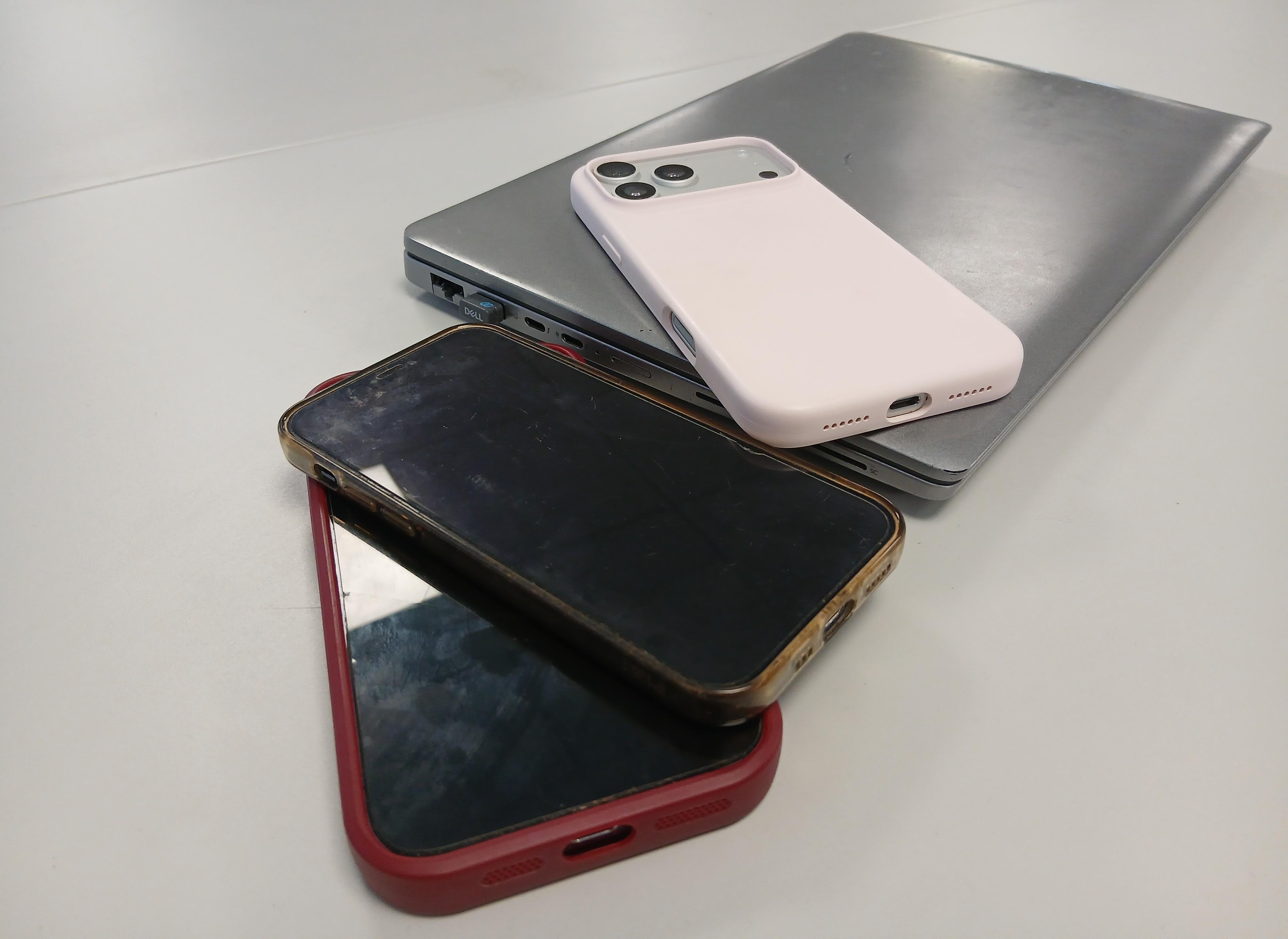 This is an image of a laptop and mobile phones