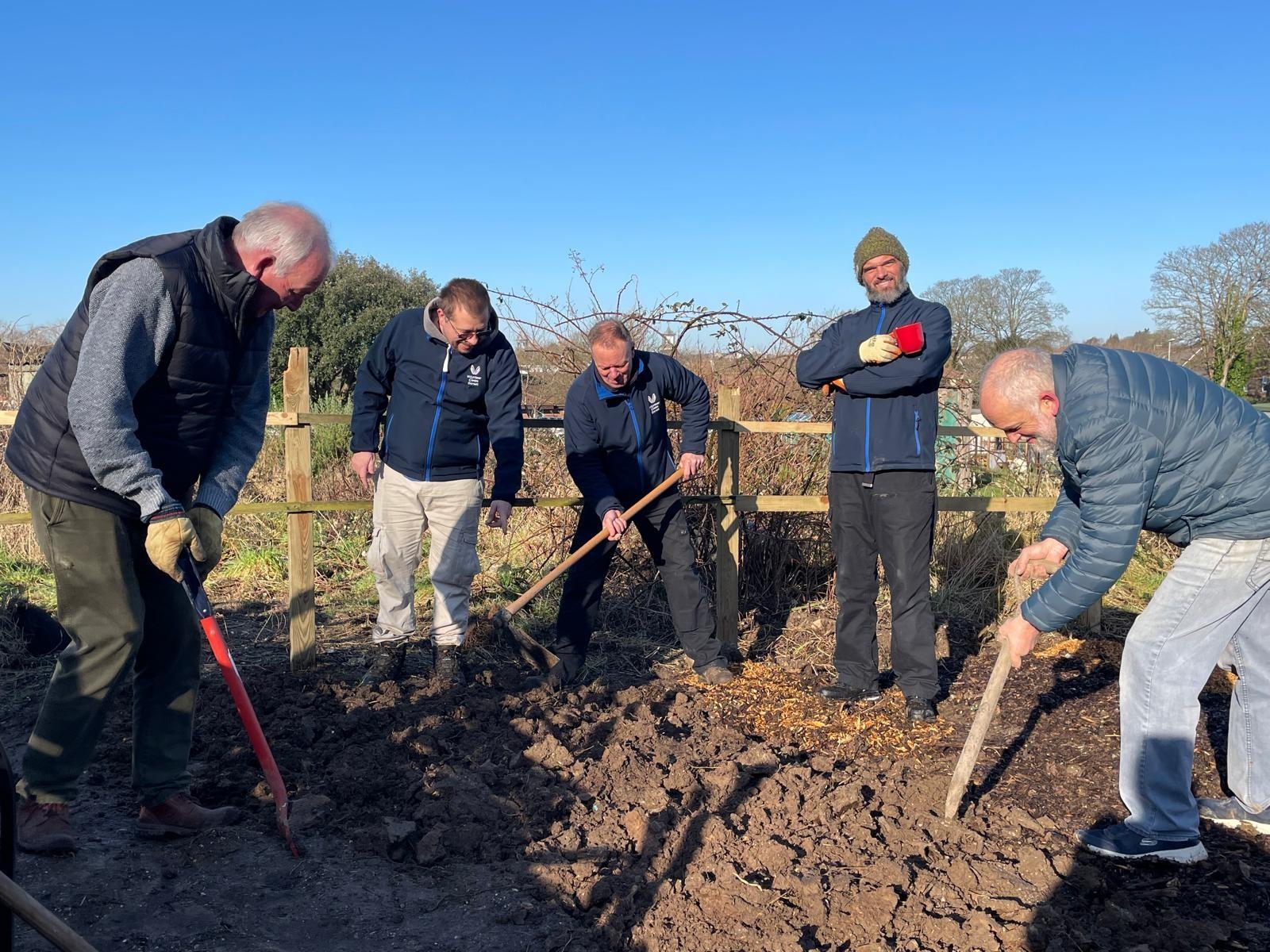 This image shows volunteers from Volunteer Centre Dorset digging a garden