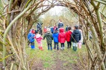 children outside seen through a willow arch