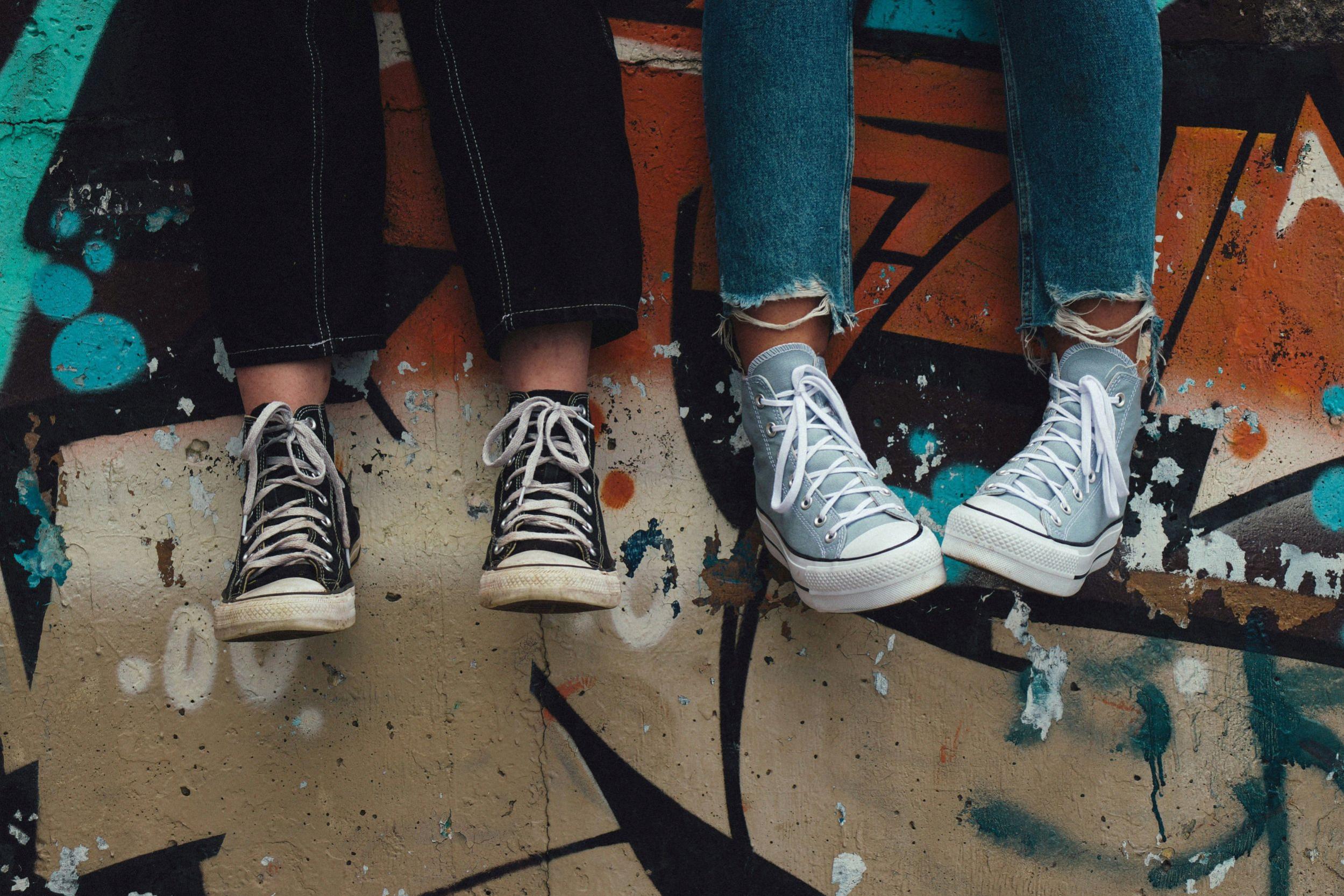 This is an image of the feet of two young people