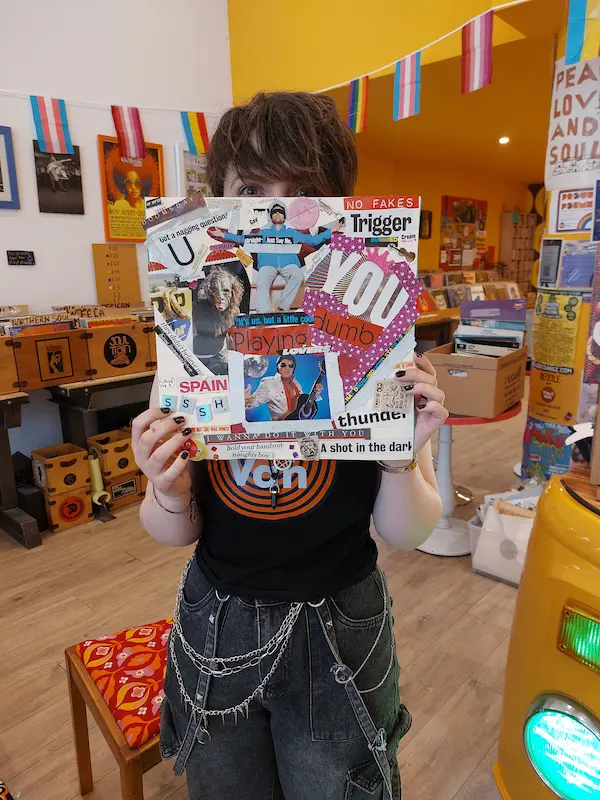 Picture of a person holding up a vinyl cover created by participants