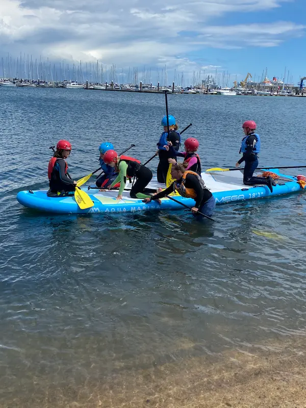 group taking part in stand up paddleboarding