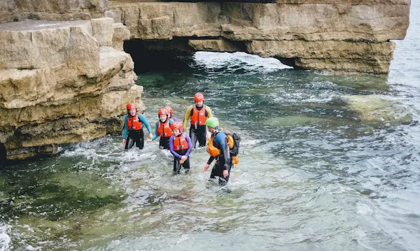 picture of a group in the sea, taking part in coasteering