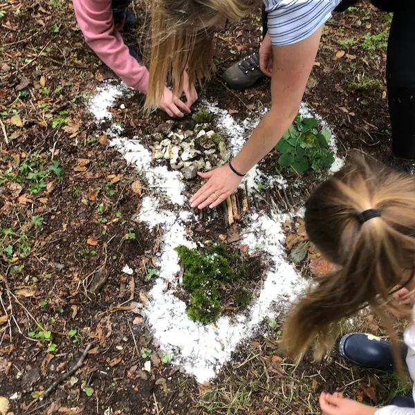 A picture of people creating wild art on the ground
