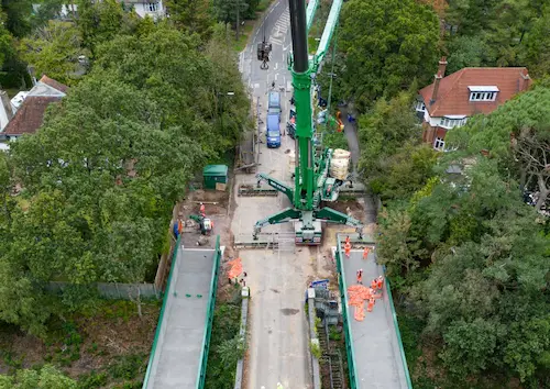 Aerial view of active travel bridge being installed both sides alongside the road bridge over the railway line – at Glenferness Avenue Bournemouth. Picture shows   