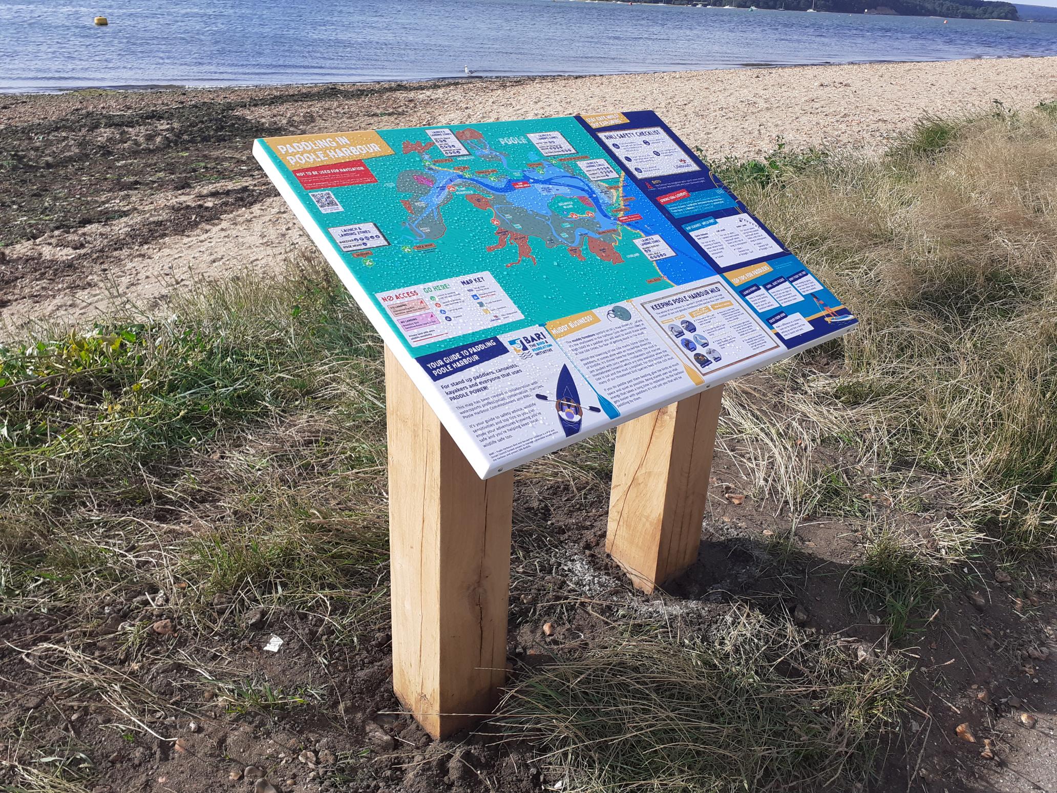 A signage board outling the areas where people can paddle-sport around Poole Harbour.