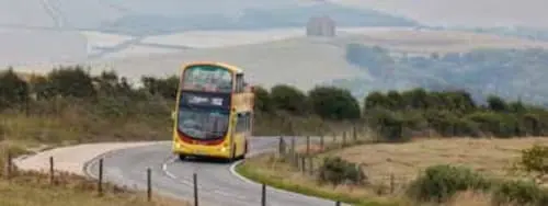 A bus travelling uphill along a winding road near Abbotsbury, surrounded by open countryside. The image highlights the importance of reliable public transport in connecting rural communities across Dorset’s varied landscape.