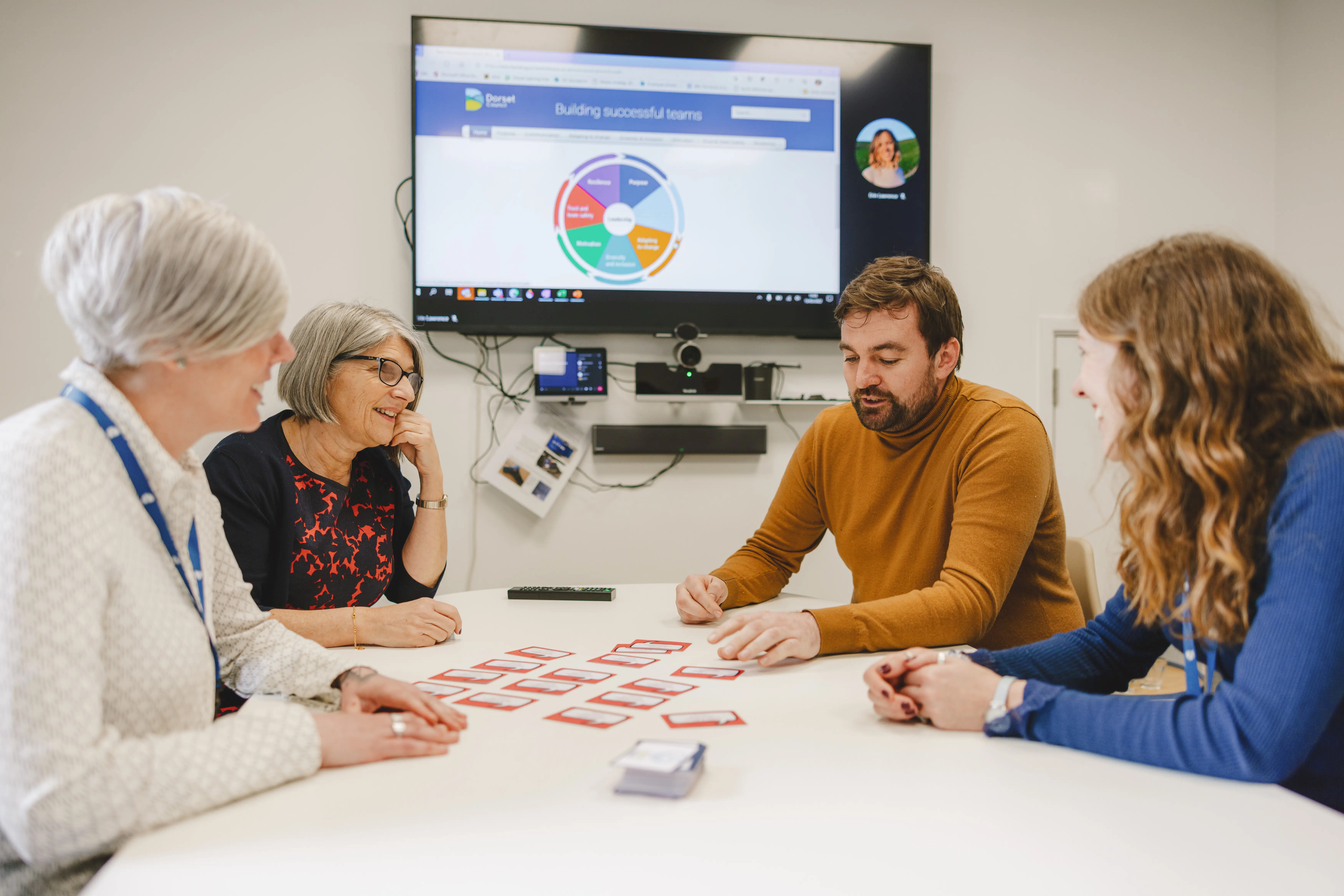 Colleagues meeting around a table in discussion