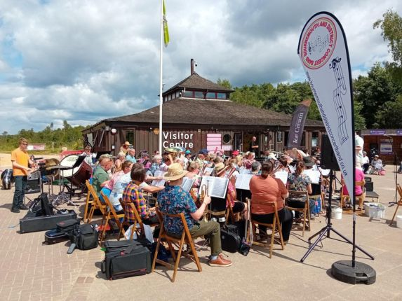 The Bournemouth and District Concert Band playing outside the Avon Heath Visitor Centre in the sunshine