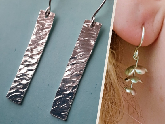 Two pairs of handmade silver earrings shown close up, including long textured bar earrings and small dangling disc earrings worn on an ear.