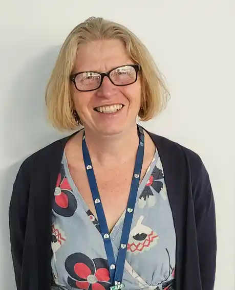 Julia Ingram, Director of Adult Social Services, smiling woman with short blonde hair, a flowery blue top and navy cardigan. 