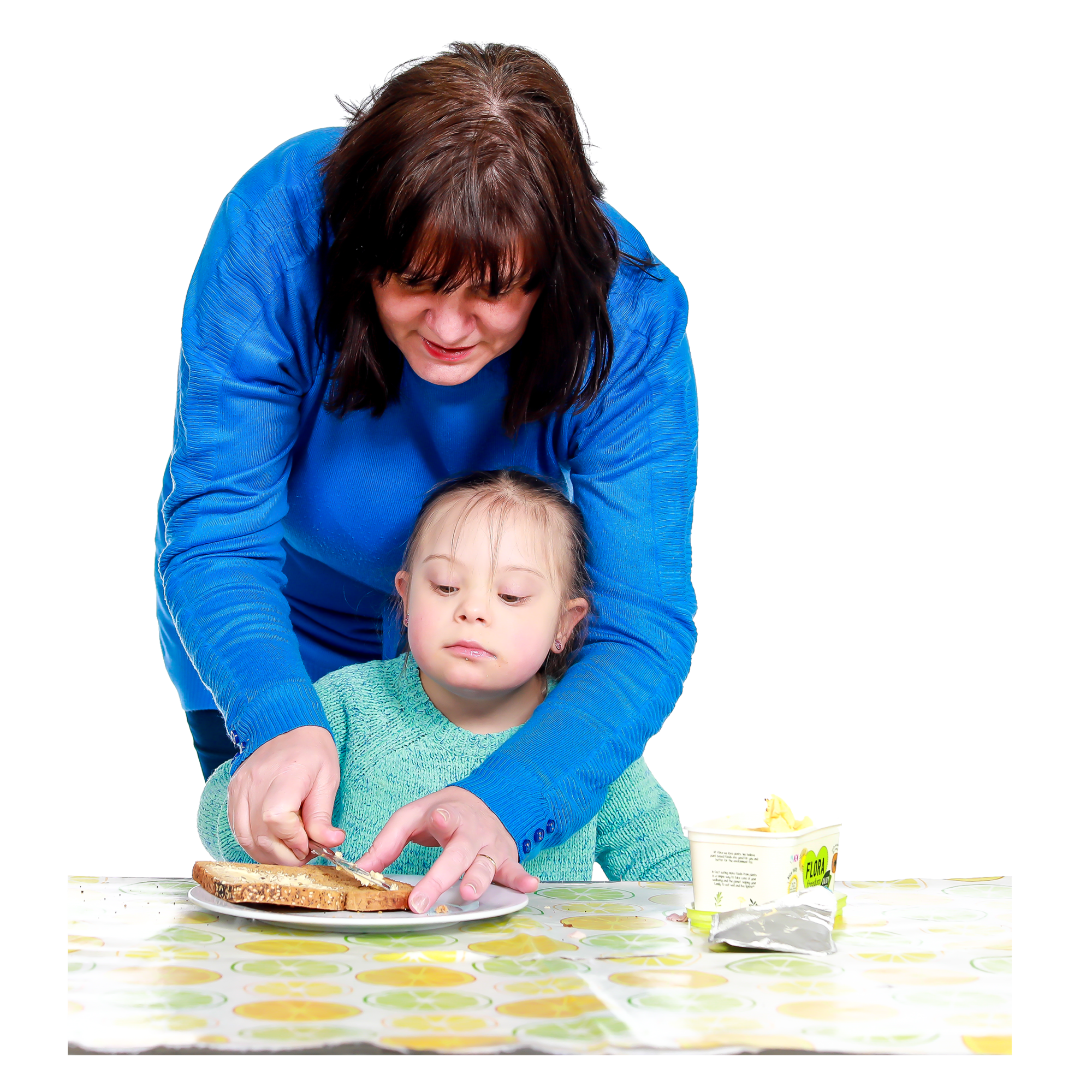 An adult making a sandwich with a small child
