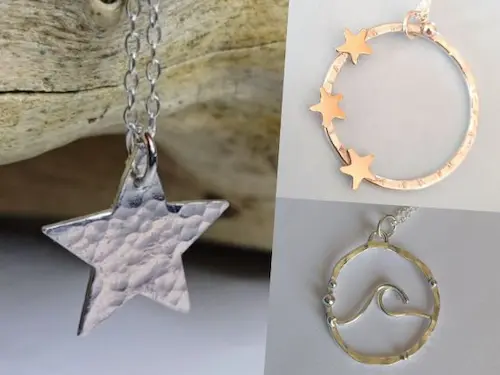 Silver and gold handmade pendants, including a star, a star‑decorated ring and a wave design.