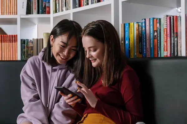 Picture of a couple of friends on their phone