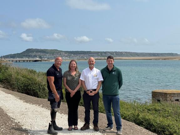 the photos are, from left: Daniel Pullenger, Waterside Groundsman; Cllr Clare Sutton, Matt Way, Waterside Operations Director; and Russell Goff, Greenspace Manager at Dorset Council