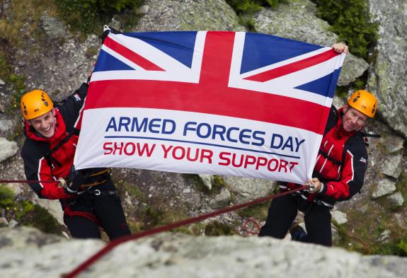 Armed Forces Flag held by two mountaineers saying show your support