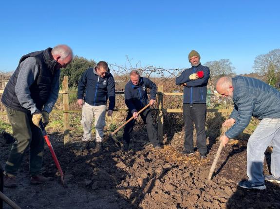 This image shows volunteers from Volunteer Centre Dorset digging a garden