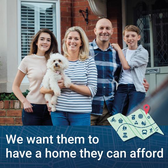 Family of four people and a dog in front of a house